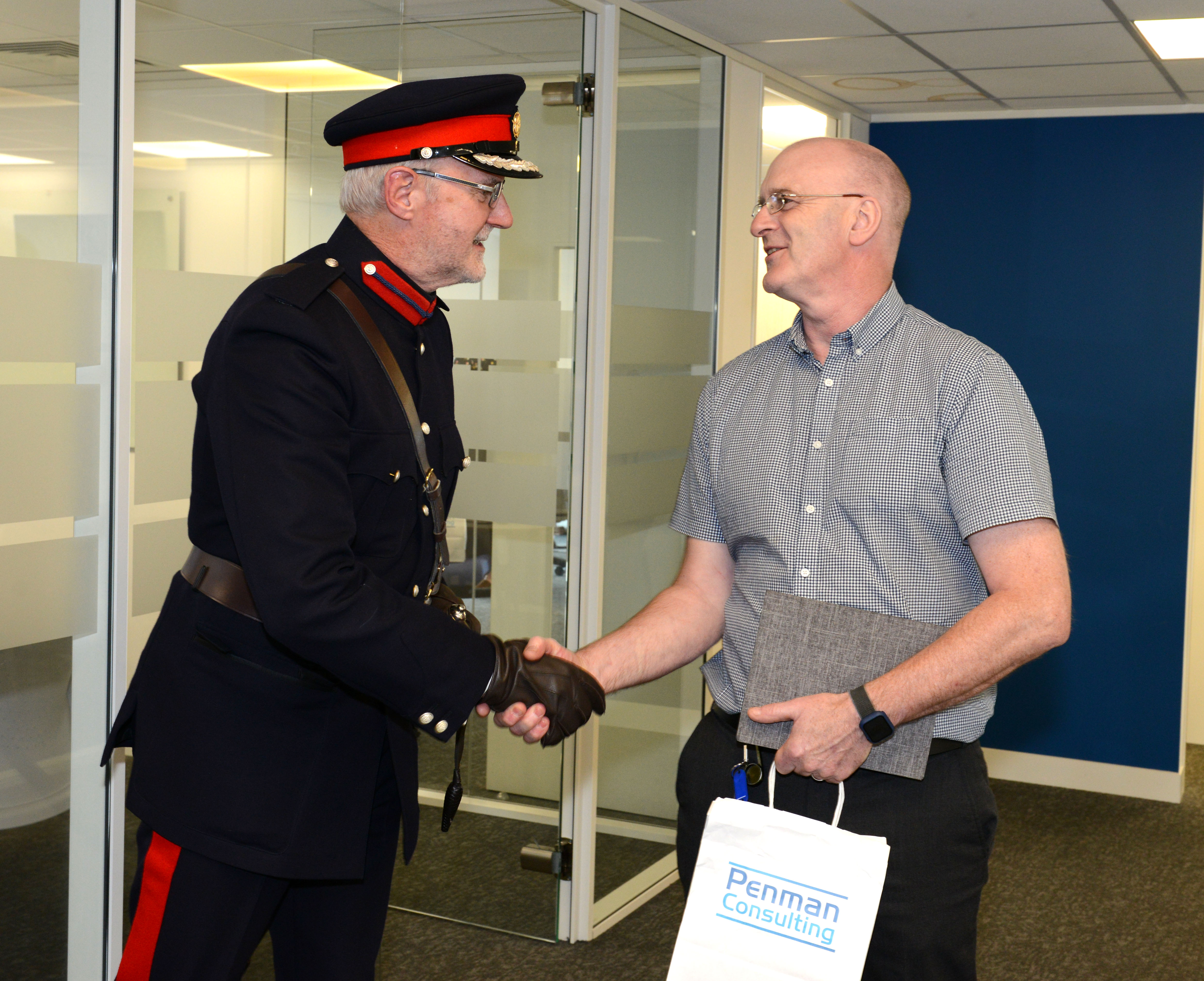 Larry Higgins during King's Award presentation at Penman Consulting Office